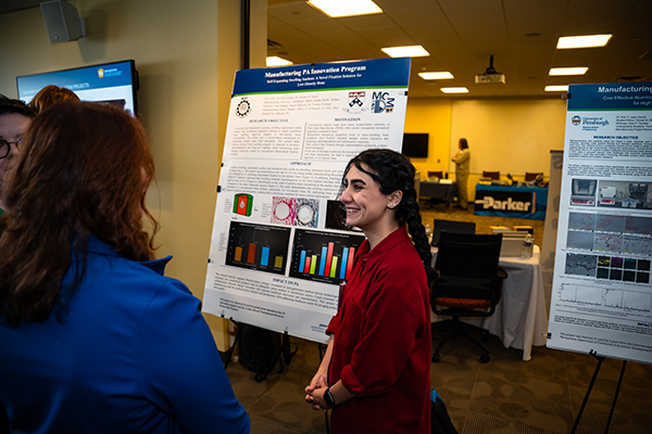 A student presenting her poster