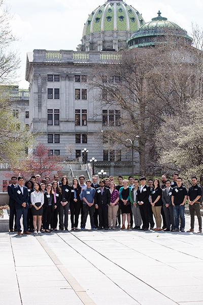 About thirty students in front of the state capitol in Harrisburg