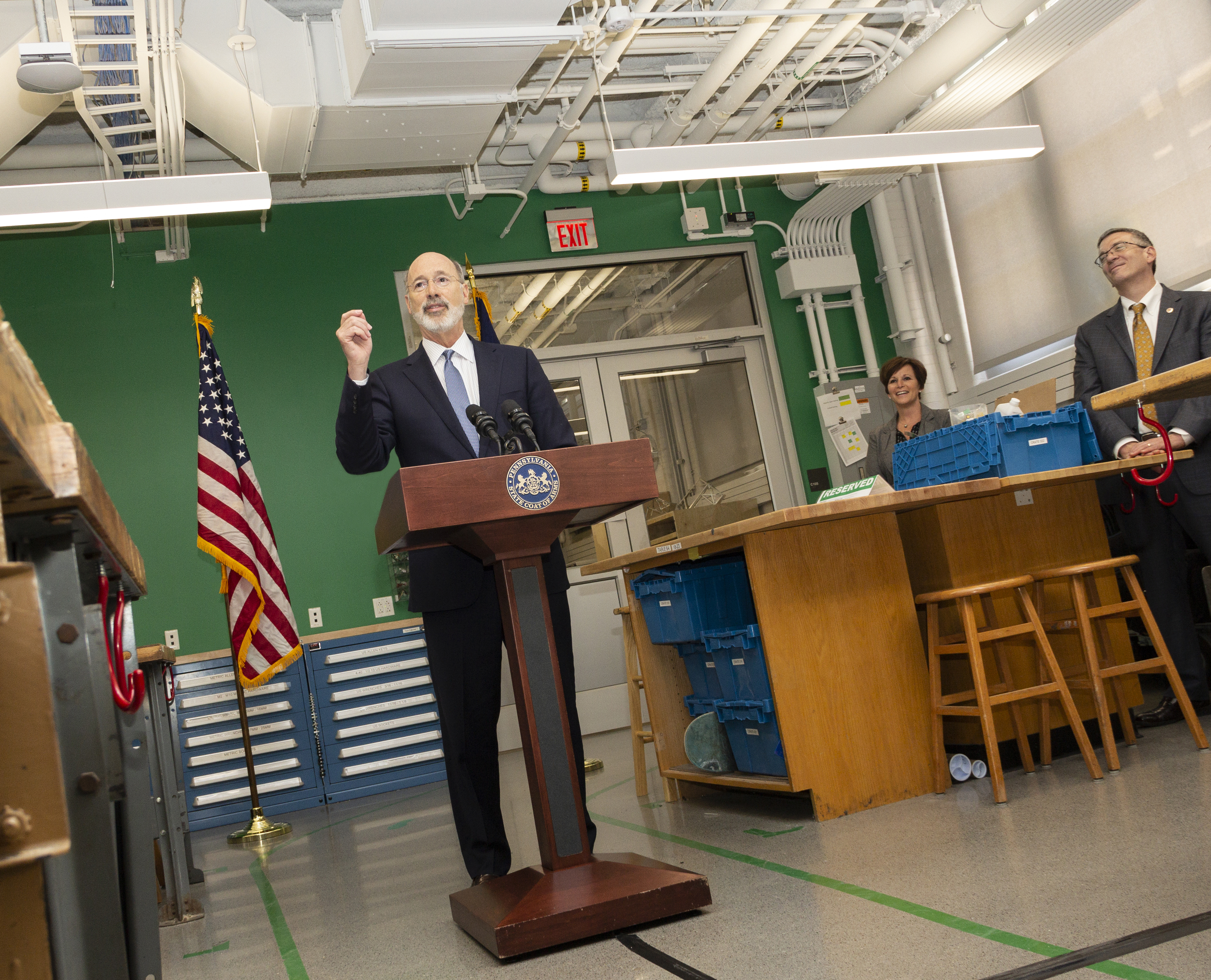 Governor Tom Wolf speaking at a podium.